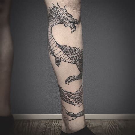 A Dragon Tattoo Design On The Leg