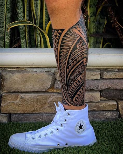 A Man S Leg With Some Tattoos On It