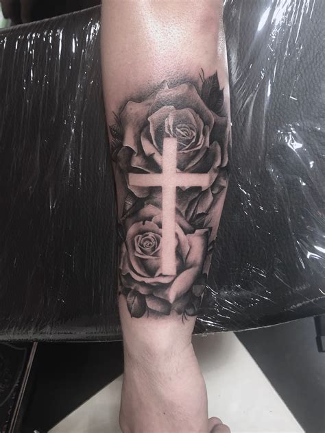 A Rose With A Cross Tattoo On It