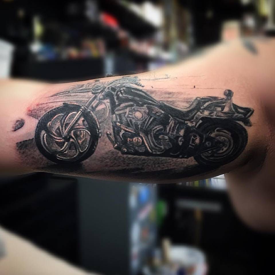 A Tattoo On The Arm Of A Man With A Motorcycle