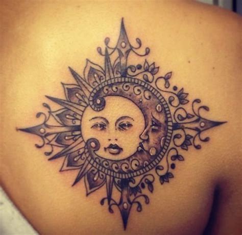 A Woman S Back With A Sun And Moon Tattoo Design On Her Left Shoulder