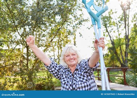 Cheering Senior Woman With Crutches In Rehab Stock Image Image Of