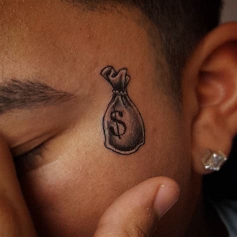 Explore The Meaning Behind Cool Money Tattoos Tattooswin Money Bag Tattoo Face Tattoos