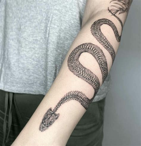 Large Snake Skeleton Tattoo Located On The Upper Arm