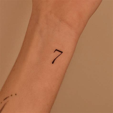 Minimalistic Tattoo Of The Number 7 Placed On The