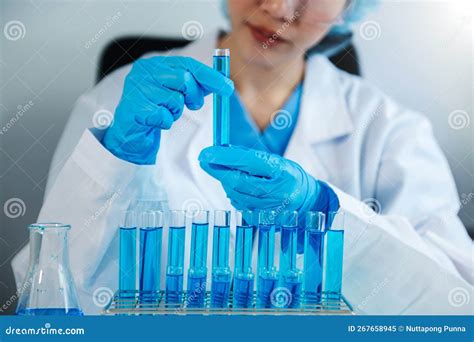 Scientist Mixing Chemical Liquids In The Chemistry Lab Researcher