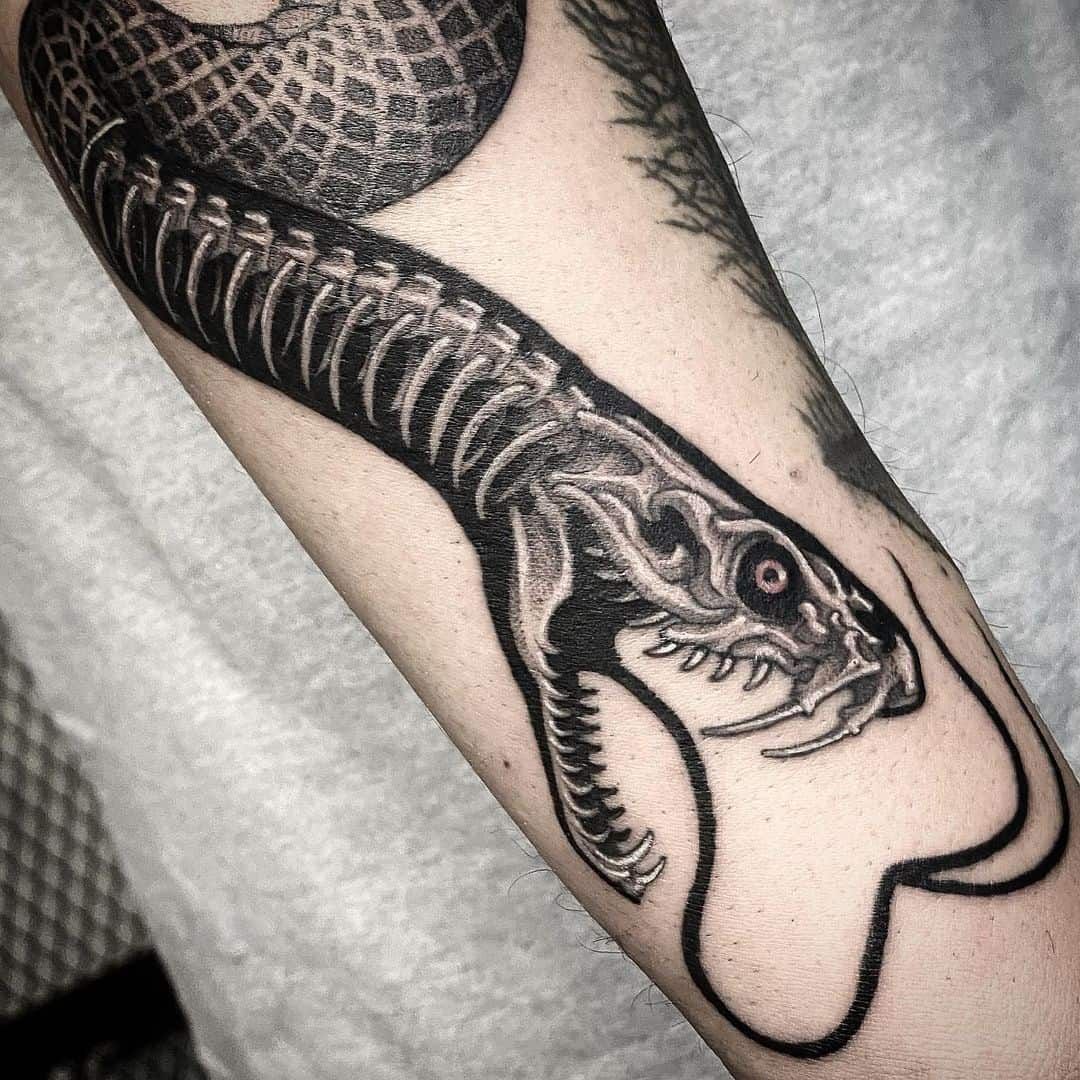 Snake And Skeleton Snake Tattoos Located On The