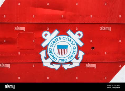 The Iconic Coast Guard Symbol On A Red Banner On The Outside Of A Ships