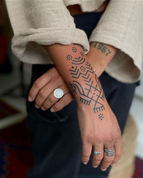 Two Different Tattoos On The Arms Of People Who Are Both Wearing Purple